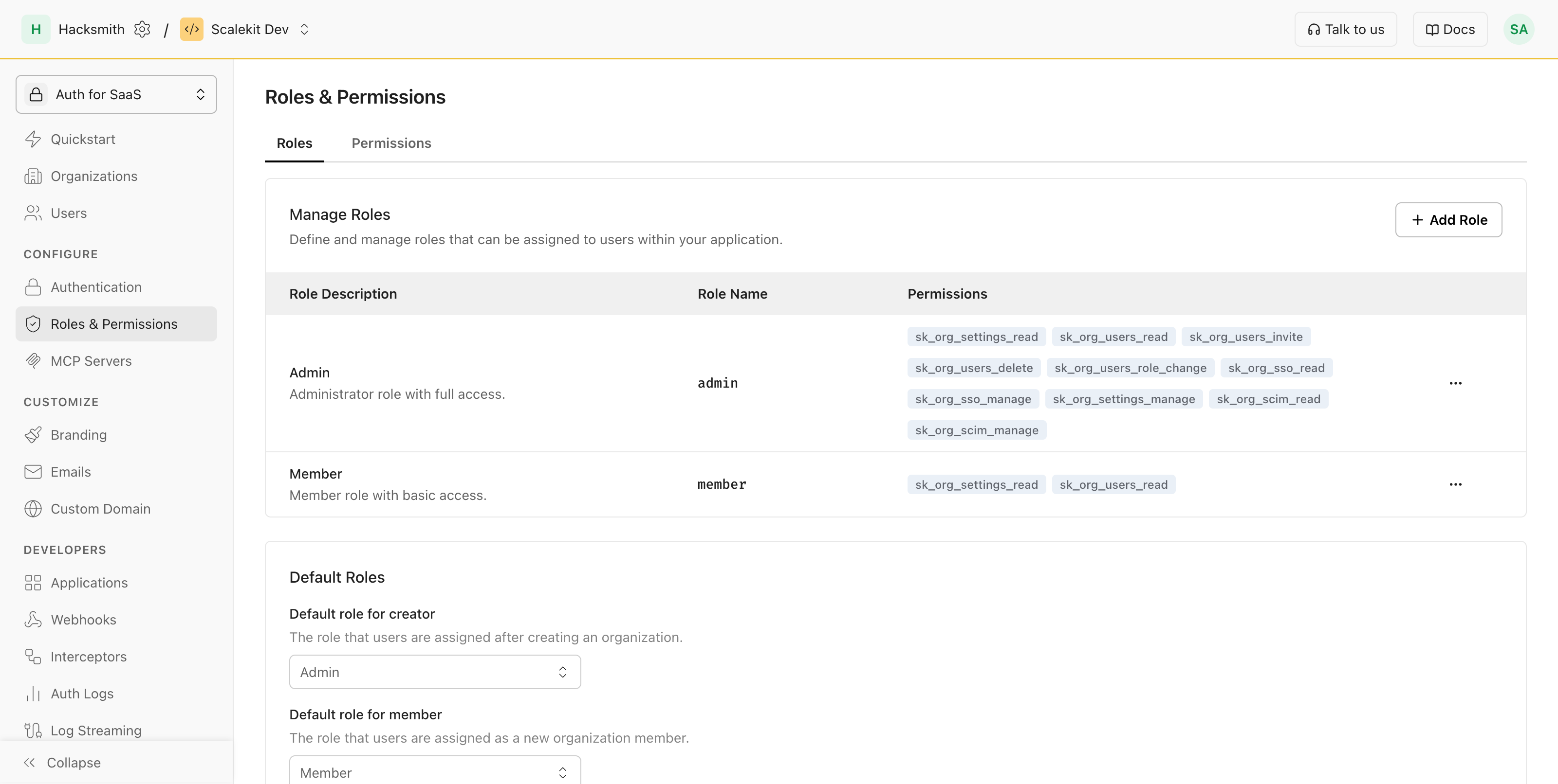 Scalekit dashboard Roles & Permissions page showing the Manage Roles table with admin, member, and viewer roles and a Default Roles panel